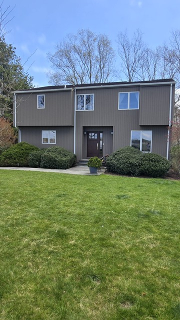 Modern two-story home with gray exterior paint and green lawn